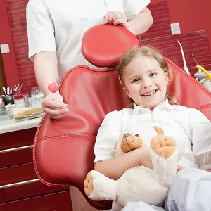 Happy girl in dental chair